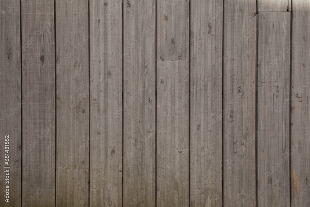 brown planks wooden background of fence wall of vertical wood boards on a horizontal facade