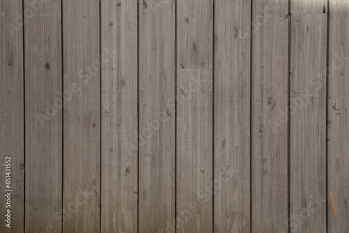 brown planks wooden background of fence wall of vertical wood boards on a horizontal facade