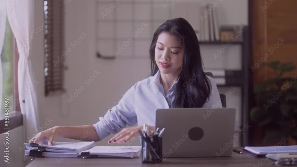 Young Successful Asian Businesswoman Sitting at Desk Working on Laptop Computer Woman working with Big Data e-Commerce in office. Young Successful Asian Businesswoman Sitting at Desk Working on Laptop Computer Woman working with Big Data e-Commerce in office.