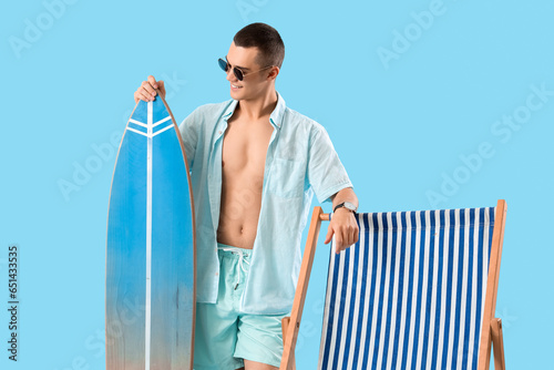 Teenage boy with surfboard ...