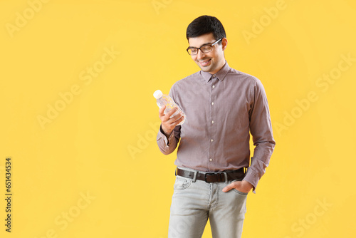 Young man with bottle of wa...