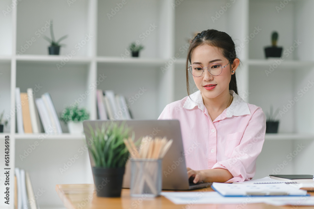 Image of young beautiful joyful woman smiling while working with laptop in office. Image of young beautiful joyful woman smiling while working with laptop in office.