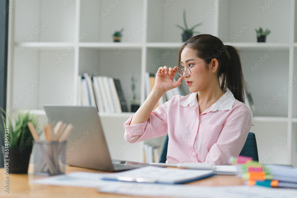 Image of young beautiful joyful woman smiling while working with laptop in office. Image of young beautiful joyful woman smiling while working with laptop in office.