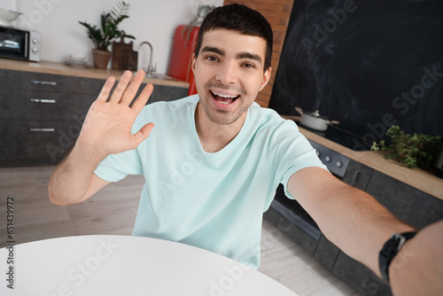 Young man video chatting in...