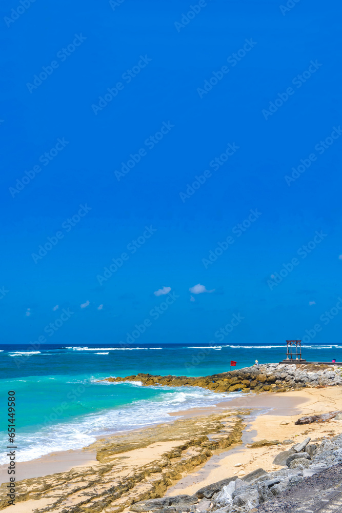 White sand, turquoise waters against the blue sky at Pandawa Beach, Bali, Indonesia.