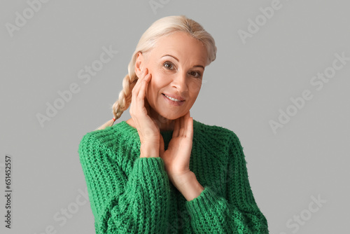 Mature woman on grey backgr...
