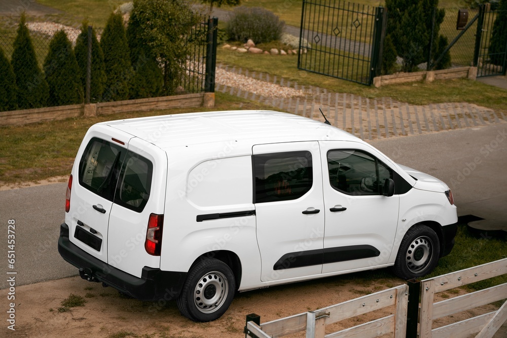 Efficient White Delivery Van on the Move. Modern Cargo Courier.  White Van Transporting Parcels on the Road