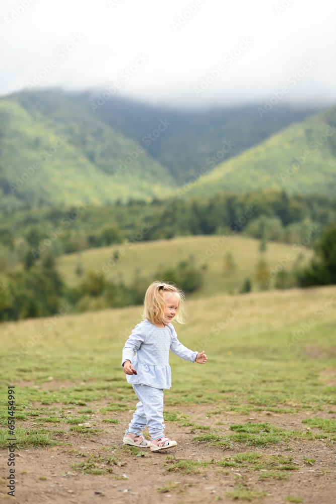 small girl walking in Carpathian mountains, Ukraine small girl walking in Carpathian mountains, Ukraine