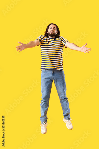 Jumping bearded young man o...