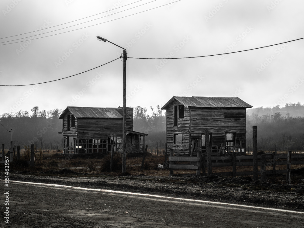 Ruined wooden houses in a foggy environment