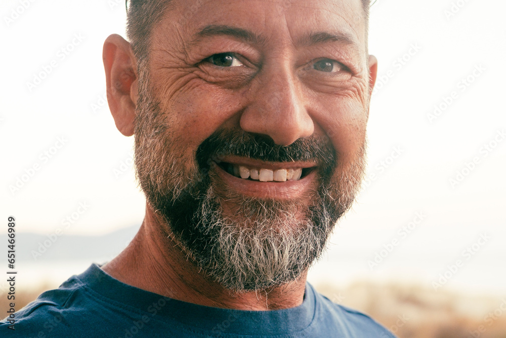 Close up portrait of happy man cheerful looking on camera. One adult mature male caucasian smile with confident and serene expression. White outdoor sky background. People and age happiness lifestyle - obrazy, fototapety, plakaty 