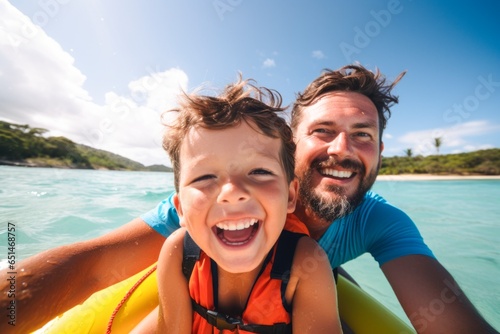a man and his young boy rafting together wearing life jackets © XC Stock