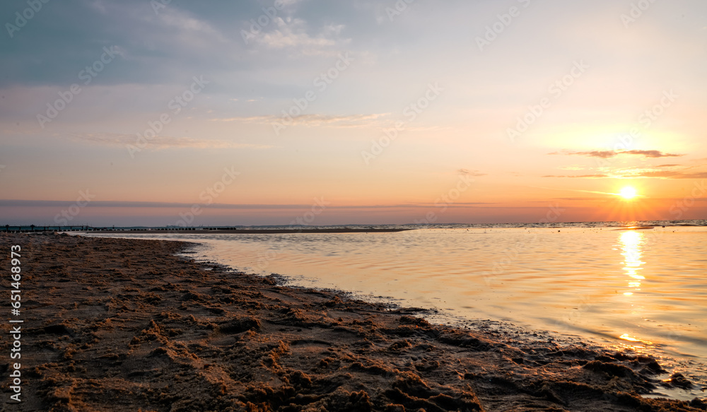 Sunset on the Baltic Sea in Poland. Landscape in the evening with setting sun by the sea. Sunset on the Baltic Sea in Poland. Landscape in the evening with setting sun by the sea.
