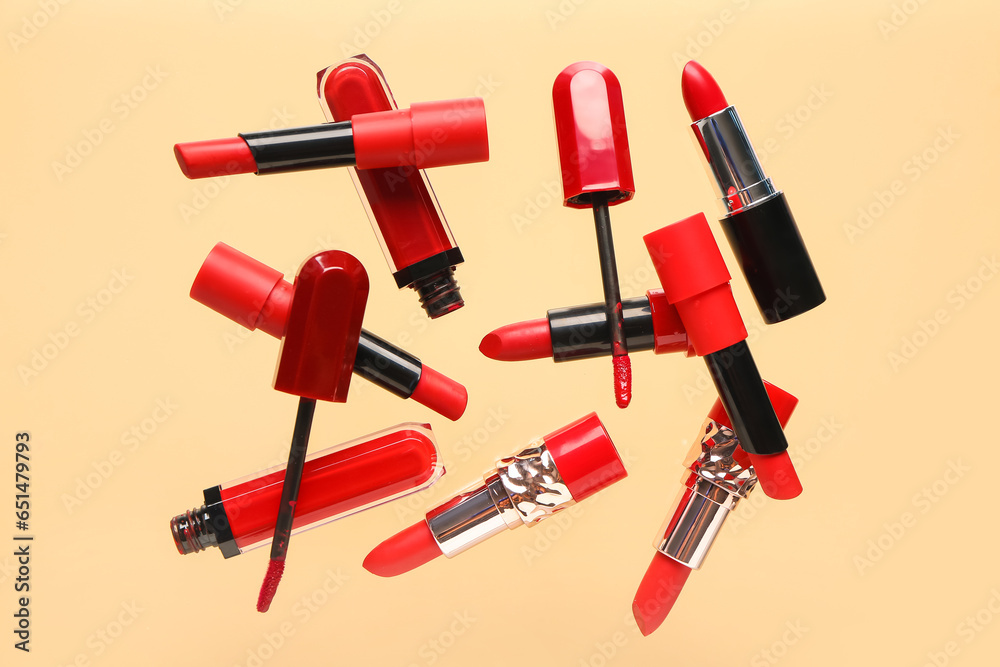 Flying red lipsticks on color background Flying red lipsticks on color background