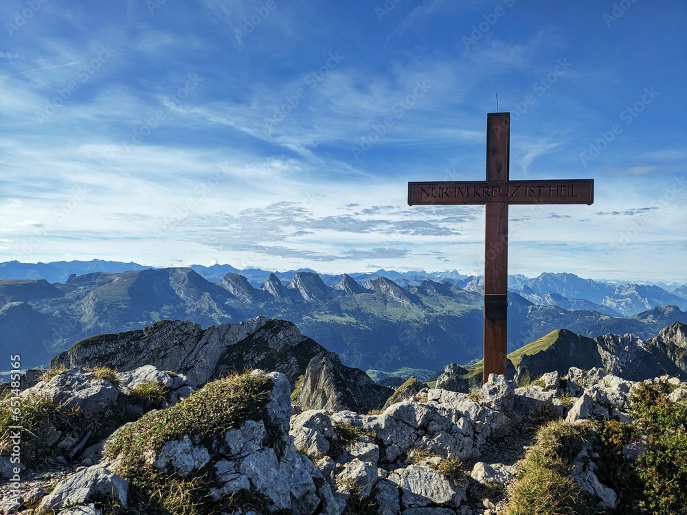Summit cross. Religious cross on the highest point of a mountain. Freedom through God. High quality photo.