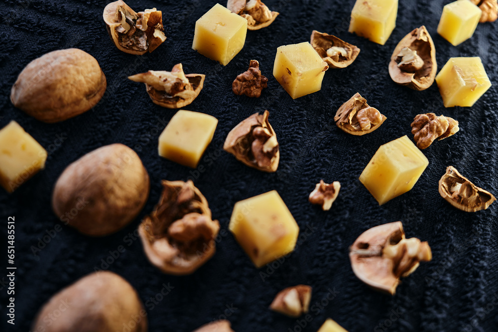walnut and cheese at close range on a dark background