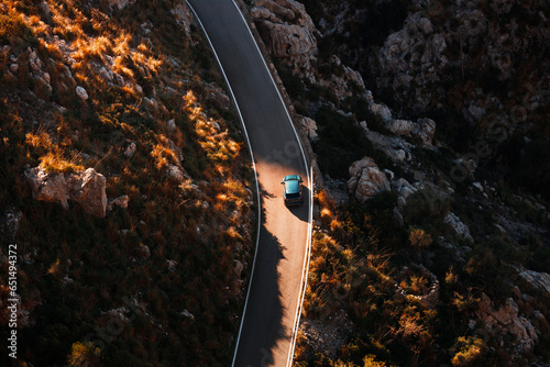 Aerial view of a car traveling across a scenic highway. Roadtrip during the autumn season