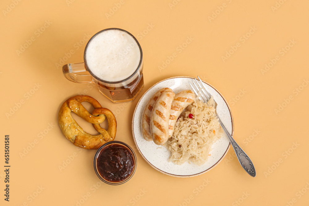 Plate with tasty Bavarian sausages, sauce, sauerkraut, pretzel and mug of beer on beige background. Oktoberfest celebration Plate with tasty Bavarian sausages, sauce, sauerkraut, pretzel and mug of beer on beige background. Oktoberfest celebration