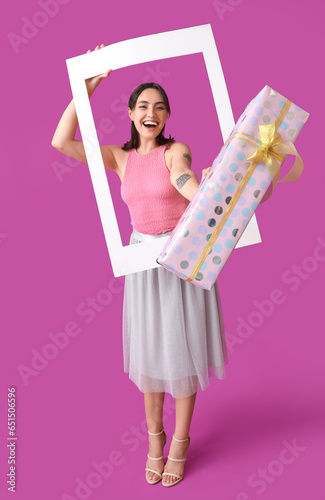 Excited young woman holding...