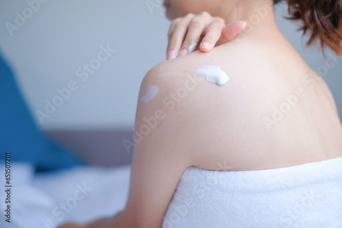 Woman applying natural cream, Woman moisturizing her back with cosmetic cream, Spa and Manicure concept.