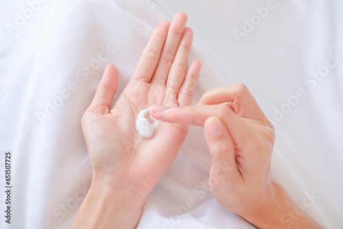 Woman applying natural cream, Woman moisturizing her hand with cosmetic cream, Spa and Manicure concept.