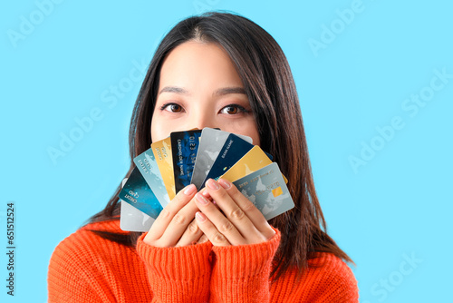 Young Asian woman with cred...