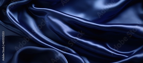 Luxury silk satin backdrop in dark blue shade Elegant shine and gentle creases Ideal for web banners and design Tabletop view perfect for Christmas and Valentine s Day