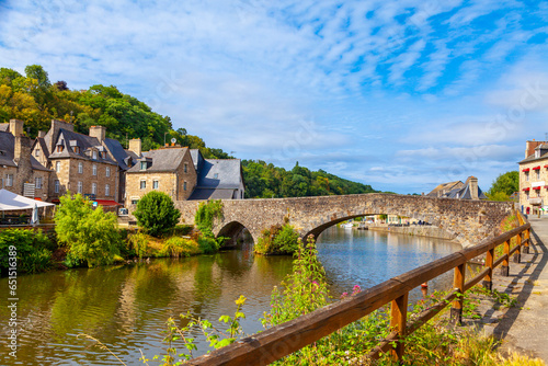 panoramic view of old stone bridge and historical medieval houses reflecting in La Rance river in Dinan town port