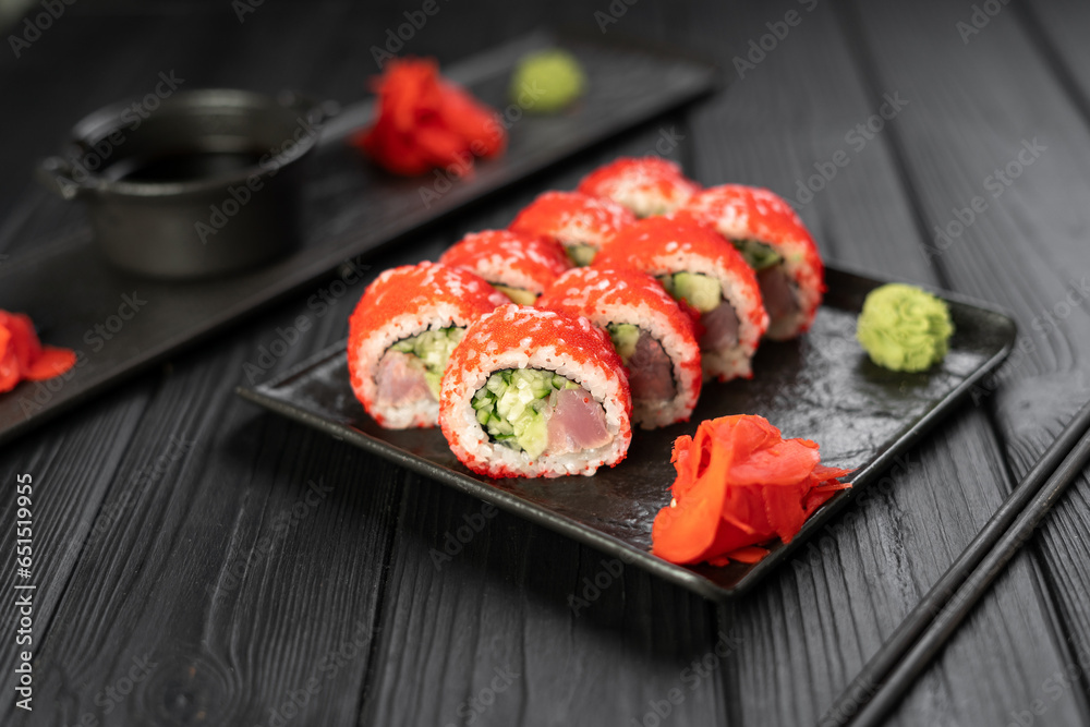 Sushi set with caviar, avocado and tuna on black slate plate. Japanese cuisine concept. Sushi set with caviar, avocado and tuna on black slate plate. Japanese cuisine concept.
