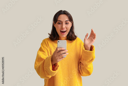 Young woman in yellow sweat...