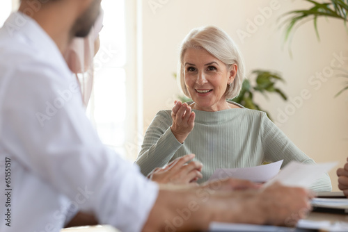 Εκτύπωση καμβά Focus on middle-aged businesswoman company owner business coach team leader talking ask question to participant during group meeting in office