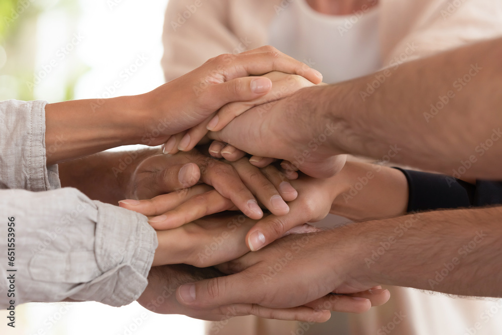 Close up view group of mates businesspeople stacked palms hands together sharing success, giving each other support and help in business. Friendly relationships, common project, team building concept Close up view group of mates businesspeople stacked palms hands together sharing success, giving each other support and help in business. Friendly relationships, common project, team building concept