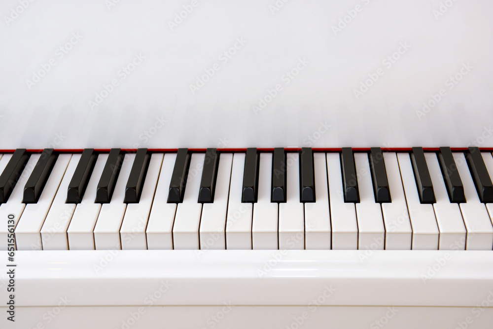 Black keys of a white piano. A musical instrument for classical music. Black keys of a white piano. A musical instrument for classical music.