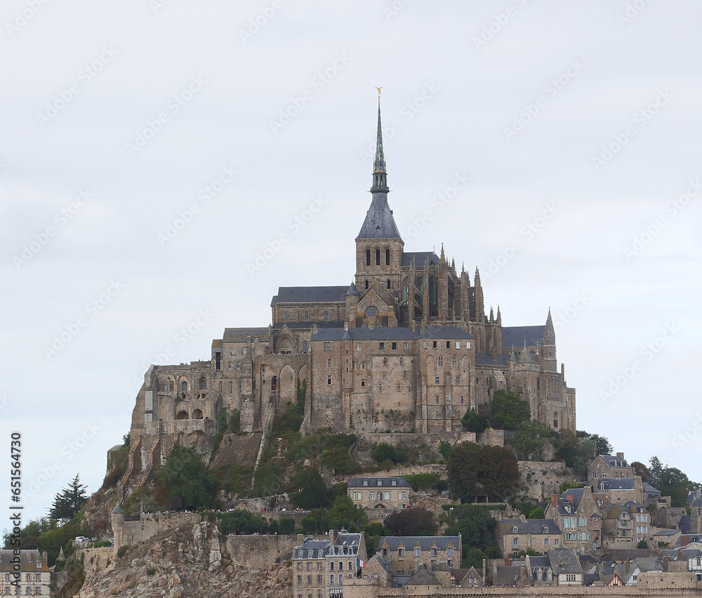 Famous Mont Saint Michel abbey above the hill of the island during low tide in France