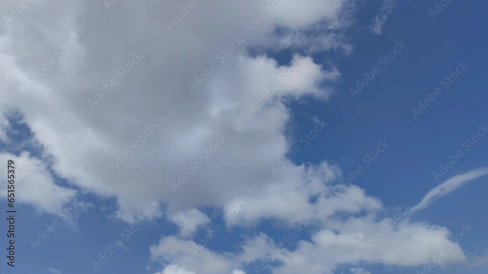 Blue sky with a huge white cloud moving across the sky Blue sky with a huge white cloud moving across the sky