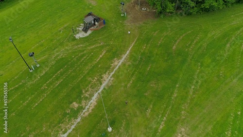 Aerial Forward Shot Of People Walking On Green Grass Near Trees - Crawfordsville, Indiana photo