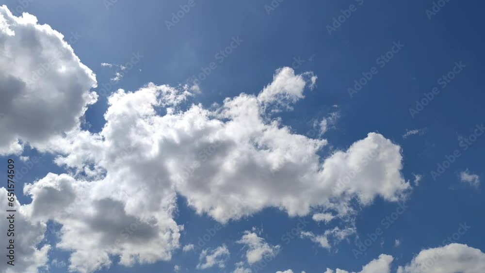 Landscape in the blue sky with rays of light with the cumulus clouds expanding and moving