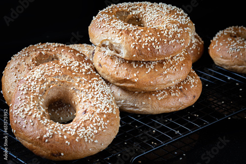Bagel. Onion bagels sprinkled with sesame seeds close-up on a black background