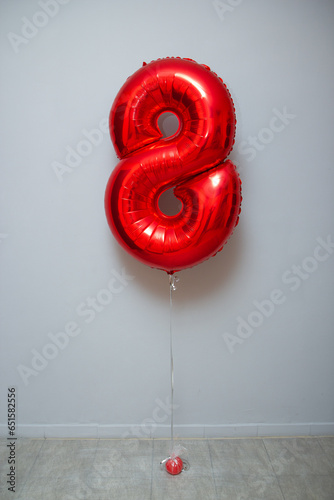 red foil number 8 balloon on white background