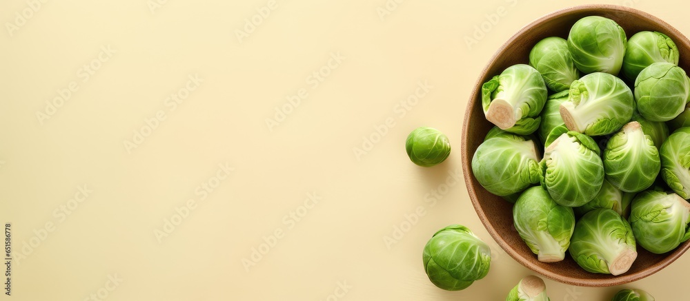 Obraz na płótnie Fresh Brussels sprouts on a isolated pastel background Copy space from above w salonie