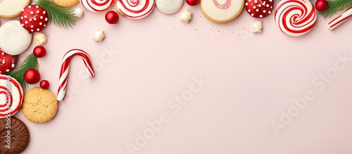 Homemade cookies topped with cream and candy cane on a isolated pastel background Copy space