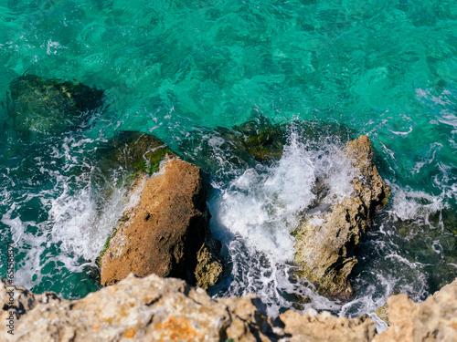 Aerial view on rocks in azure blue water