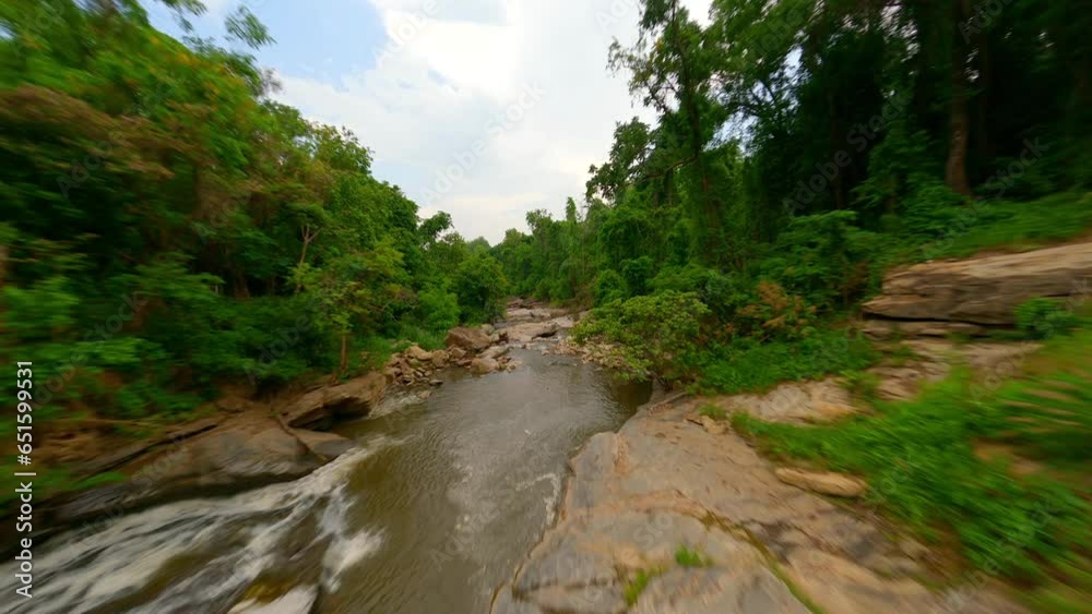FPV drone flight over a rocky mountain river in a rainforest in Thailand FPV drone flight over a rocky mountain river in a rainforest in Thailand