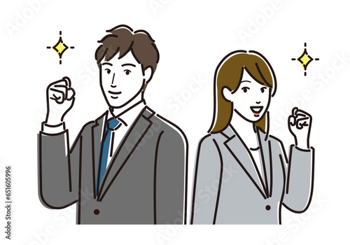 ガッツポーズをするスーツを着た男女