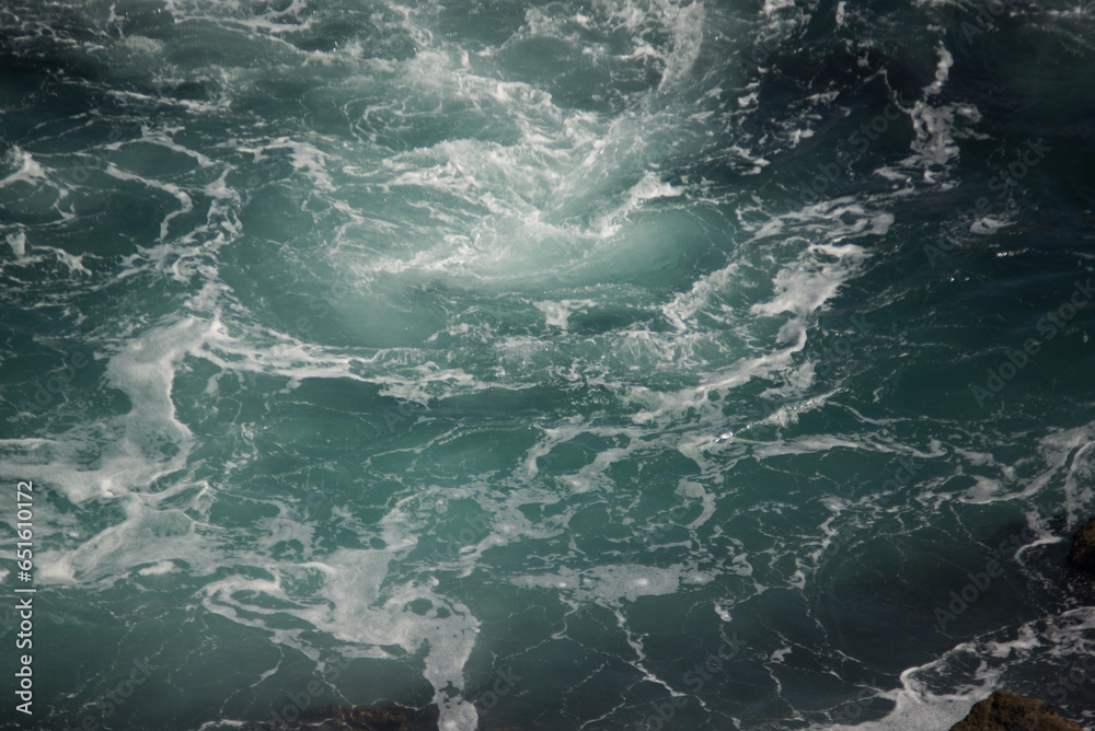 Blue-green breaking waves with white sea foam
