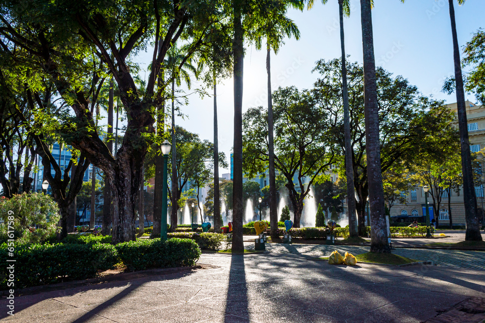 Liberty Square. Trees, palm trees. Cloudless blue sky. Sunny day.