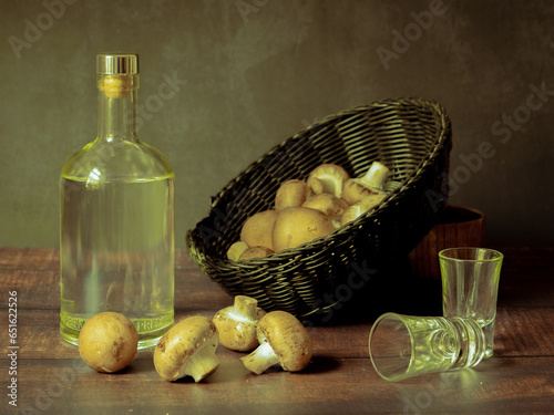 Antique-style still life with alcohol and mushrooms. photo