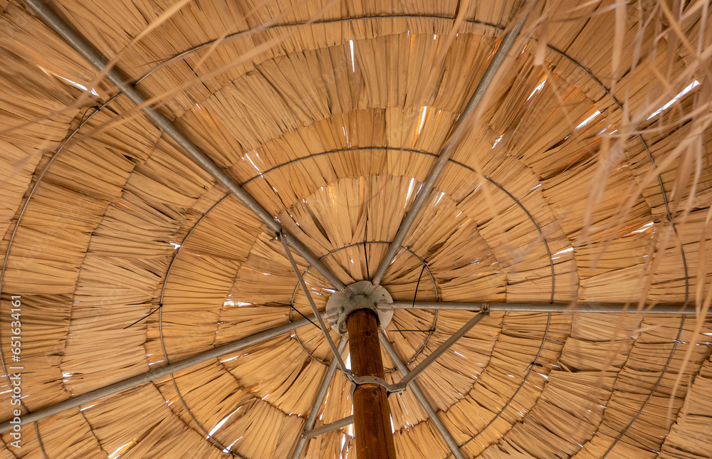 under the straw umbrella on holiday at the seaside