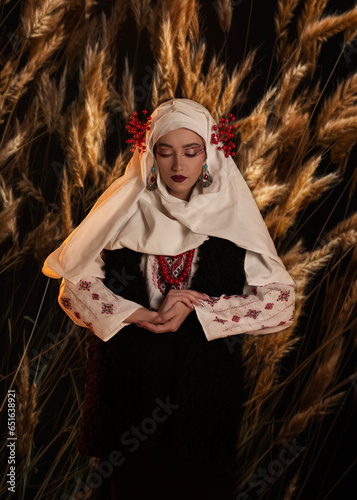 Woman as motanka . Traditional costume. Symbolism, ancient magic, force of nature, cosplay photo