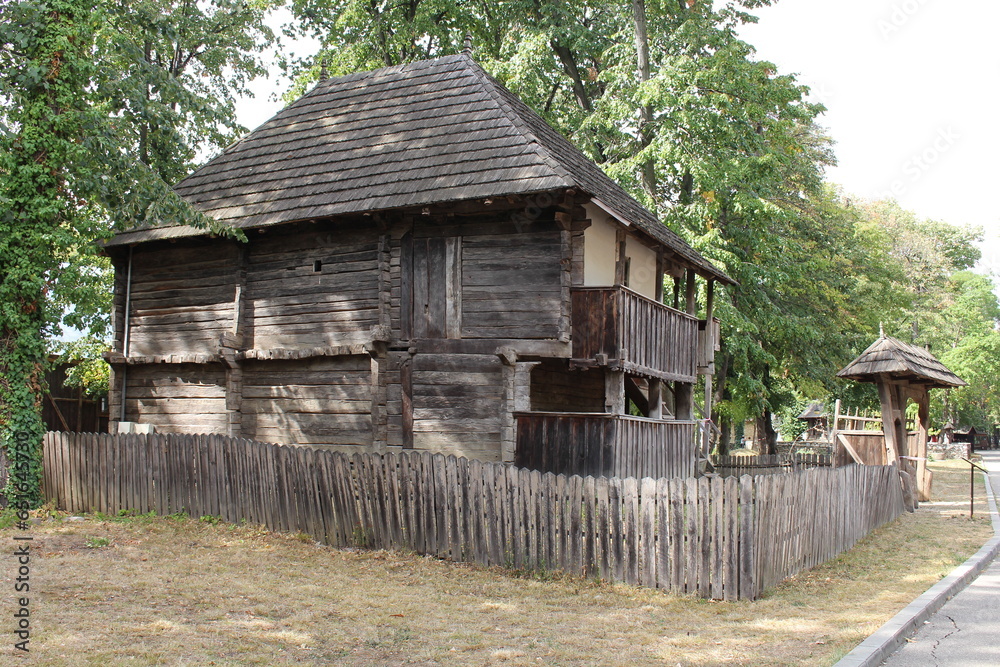 A wooden building with a fence around it